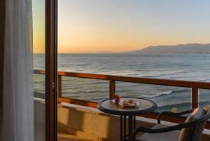 a table on a balcony with a view of the ocean at Otel Ustabaş in Hopa +27 photos