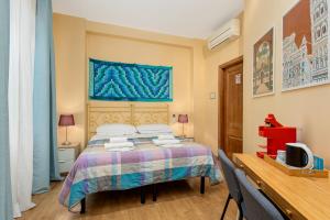 a bedroom with a bed and a desk with a tv at Hotel Por Santa Maria in Florence +25 photos