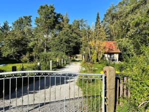 a gate on a road with a house in the background at Hoffmannshof in Torno +63 photos