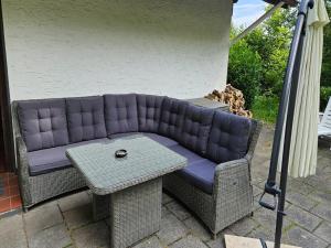 a purple couch and a table on a patio at Schöne Aussicht am Eifelsteig in Monschau +22 photos