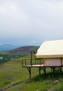 a tent sitting on top of a grass covered hill at Yagoda Moya in Khot