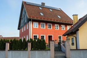 a large red brick house with a brown roof at Ferienwohnung Demmelbach in Weil