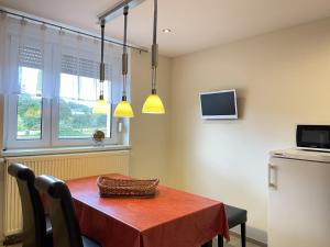a dining room with a red table and a television at Zimmer & Ferienwohnung Steuer in Leippe +51 photos