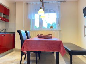 a dining room table with a red table cloth on it at Zimmer & Ferienwohnung Steuer in Leippe