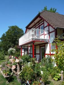 a house with a lot of flowers in front of it at Die Wohlfühloase in Frankenau