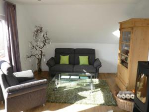 a living room with a couch and a glass coffee table at Die Wohlfühloase in Frankenau +40 photos