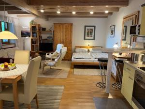 a living room with a kitchen and a bedroom at Ferienwohnung Kugler in Grafrath