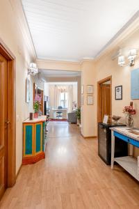 a living room with a wooden floor and a hallway at Hotel Por Santa Maria in Florence