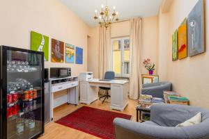a living room with a refrigerator and a desk at Hotel Por Santa Maria in Florence