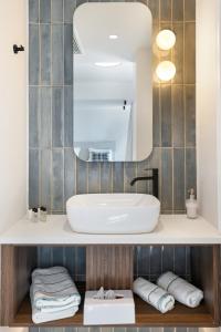 a bathroom with a sink and a mirror at Metaxa Hotel Heraklion - Urban Boutique Living in Heraklio +52 photos