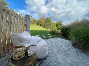 a couch sitting on a table next to a fence at Ferienhaus am Dürrbachtal in Unterleinleiter +86 photos