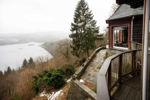 a balcony of a house with a view of a river at Waldhaus Anne in Simmerath