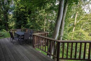 a wooden deck with a table and chairs on it at Waldhaus Anne in Simmerath