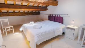 a bedroom with a white bed and a wooden ceiling at Domus Dantis - Italian Homing in Ravenna +77 photos