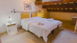 a bedroom with two beds with slippers on the bed at Domus Dantis - Italian Homing in Ravenna