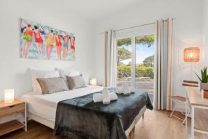 a bedroom with a bed and a large window at Villa Artemis piscine Golfe St-Trop in Grimaud