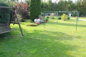 a park with a swing set in a yard at Ferienwohnung "Feldblick" Schuhmacher in Gützkow