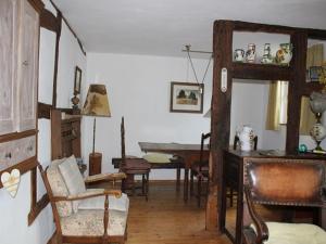 a living room with a table and a desk with chairs at Rurtalgarten in Hammer +29 photos