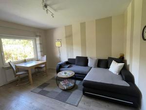 a living room with a couch and a table at Ferienwohnung Zum Geisberg in Ockfen