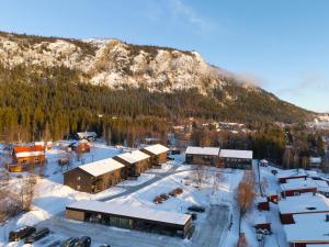 a resort in the snow with a mountain in the background at Nyhem - Funäsdalen in Funäsdalen