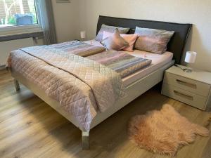 a bed in a bedroom with a rug on the floor at Ferienwohnung Zum Geisberg in Ockfen