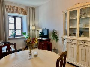 a dining room with a table and a large cabinet at Lublin Aura Residence in Lublin