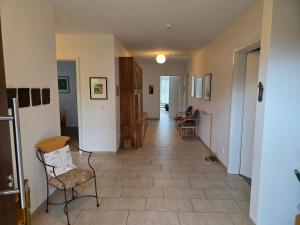 a hallway of a house with chairs and a floor at Haus Gartenglück in Barßel
