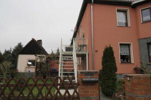 a house with a ladder on the side of it at Ferienwohnung am Technikmuseum in Dessau
