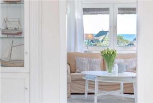 a living room with a couch and a table at Haus Meerblick in List +25 photos