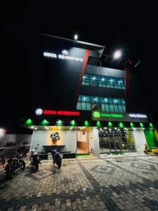 a building with motorcycles parked outside of it at night at Hota Residency in Sonepur