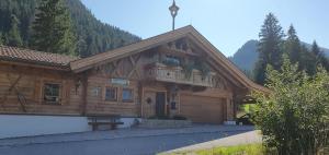 a wooden building with a balcony on the front at Haus Walina in Tannheim