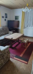 a living room with a table and a couch at Ferienhaus 2 Bernd in Barth