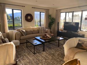 a living room with a couch and a table at Yuki's Chalet - Terrace Downs in Windwhistle