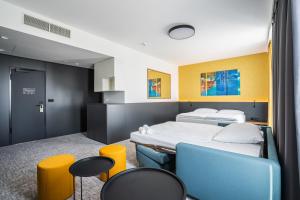 a hospital room with two beds and chairs at EA Congress Hotel Aldis in Hradec Králové +45 photos