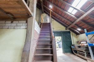 a staircase in the side of a building with a roof at Ferienwohnung Eulennest, 35230 in Schwerinsdorf