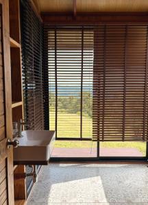 a bathroom with a sink and a large window at Hillbilly Farm in Ban Kok Kabok
