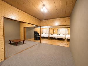 a room with two beds and a table at Hav Living in Oshima +21 photos