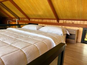 a bedroom with two beds and a wooden ceiling at Hillbilly Farm in Ban Kok Kabok
