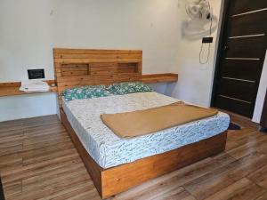 a bedroom with a bed with a wooden headboard at Poomala Holiday Village in Mulagunnathukāvu +7 photos