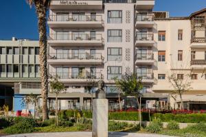 a building with a parking meter in front of it at Metaxa Hotel Heraklion - Urban Boutique Living in Heraklio