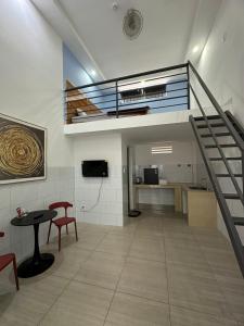 a room with a staircase and a table and chairs at Tam duc villa in Tây Ninh