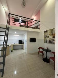 a room with a staircase and a table and chairs at Tam duc villa in Tây Ninh