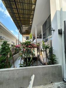 an outdoor patio with tables and umbrellas on a building at Tam duc villa in Tây Ninh