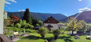 a house with a view of a mountain at Pension & Apartments Weissbriach in Weissbriach