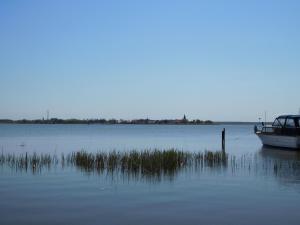 a boat is docked in a large body of water at FH am Haff B in Altwarp