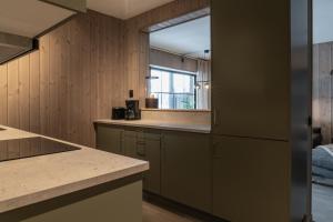 a kitchen with wood paneling and a window at Nyhem - Funäsdalen in Funäsdalen +61 photos