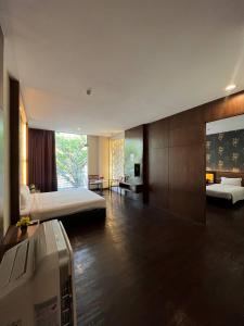 a hotel room with a bed and a bathroom at D'Wharf Hotel PD Waterfront in Kampong Bangsal Kapor