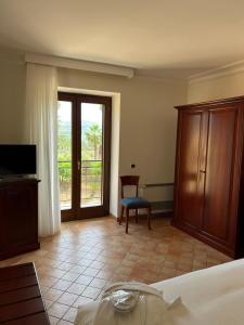 a bedroom with a bed and a sliding glass door at Villa Demetra Resort in San Leone