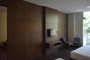 a hotel room with a tv on a wall at D'Wharf Hotel PD Waterfront in Kampong Bangsal Kapor