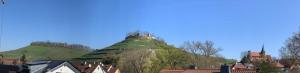 a large hill with a castle on top of it at Turmquartier Weinsberg in Weinsberg